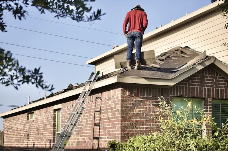 Professional roofer working on a residential roof in Rockfield